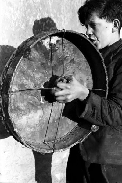 Niño cantando y tocando un bodhran en una foto tomada por el floclorista Kevin Danaher en 1946